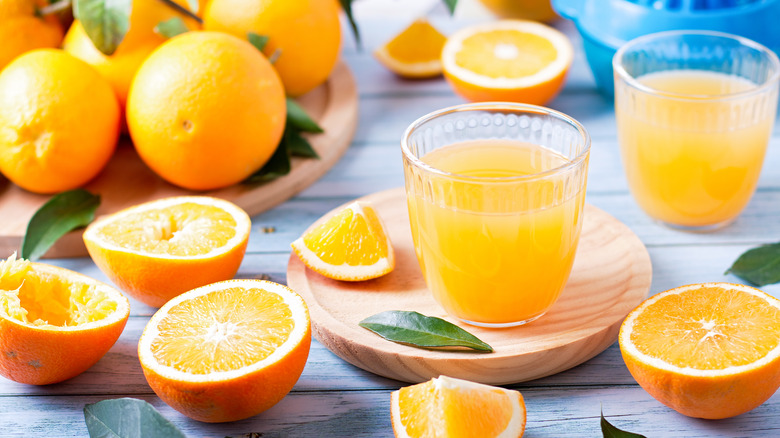 sliced oranges and glass of orange juice