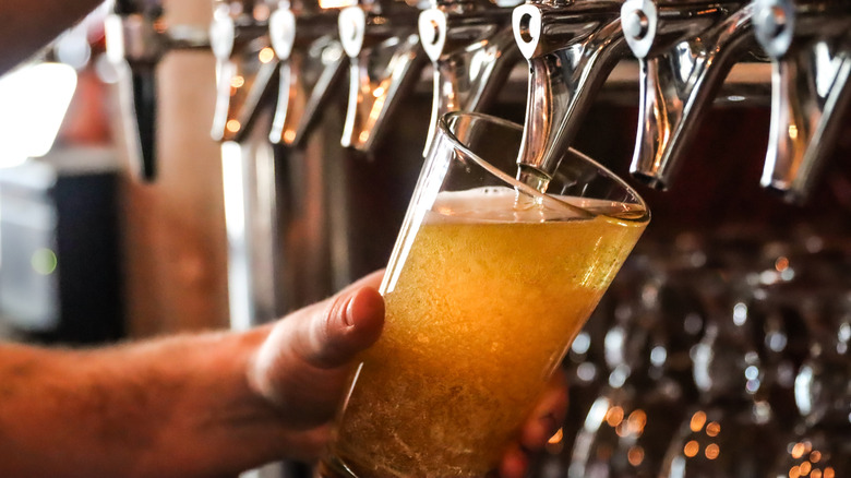 Pouring draft beer into glass