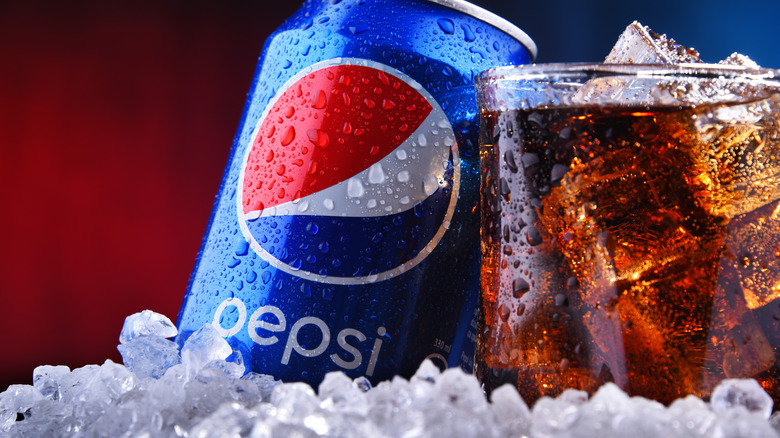 Pepsi can and glass with ice