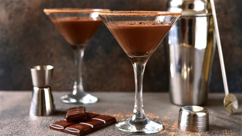A chocolate martini next to a bar of chocolate