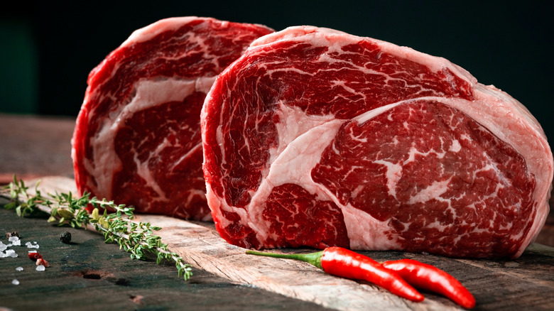 Two marbled steaks standing upright