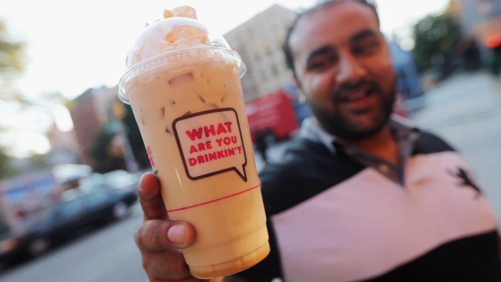 A Dunkin' drink with the branded typeface asking 'What are you drinkin'?'