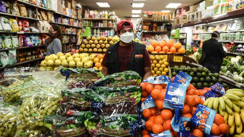 Bodega worker surrounded by veggies