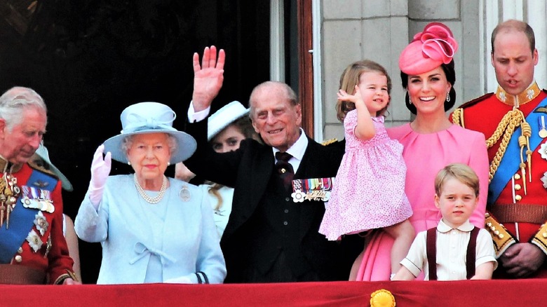 English royal family waving from balcony.