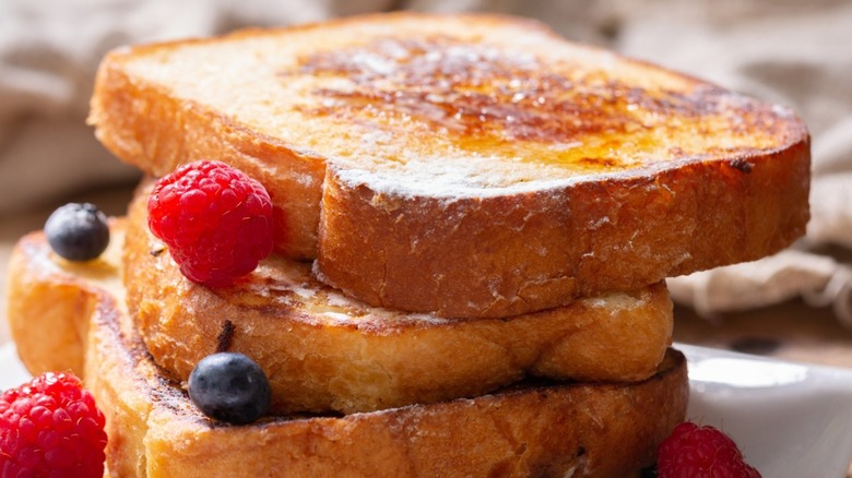 A stack of French toast slices with berries