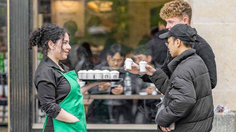 Starbucks employee handing out samples