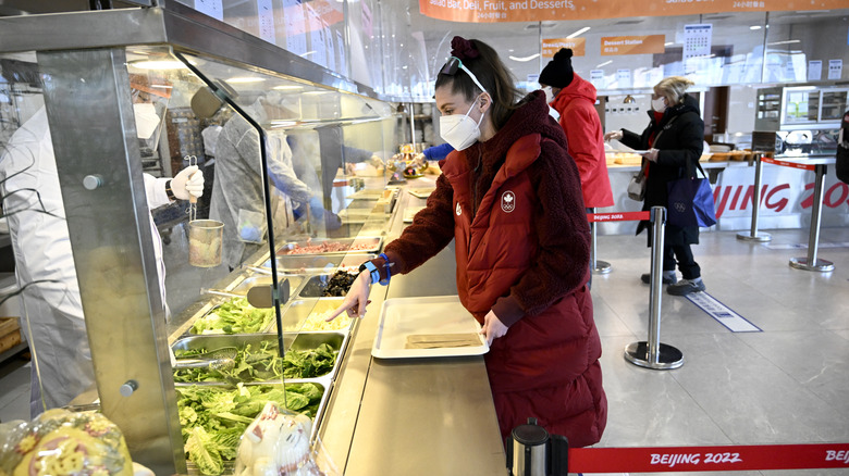 Athletes line up for food at Beijing Olympic Village