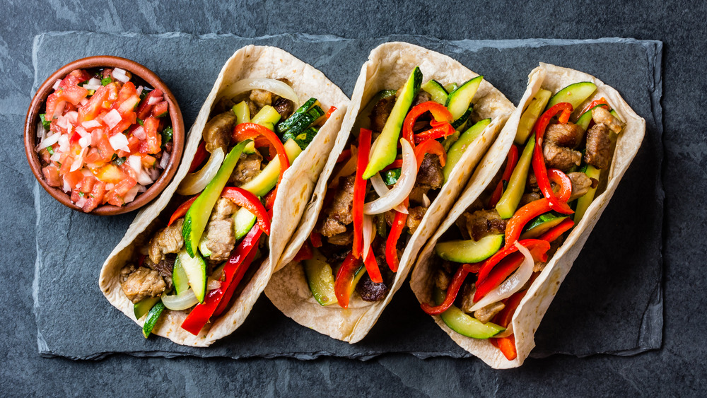 Mexican pork tacos on black background