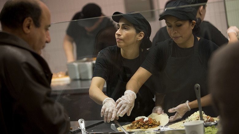 Chipotle workers serving food 