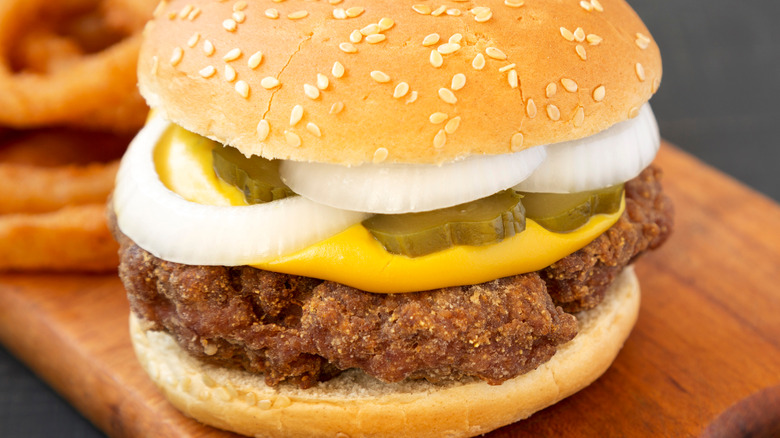 A Mississippi slugburger with onion rings in the background