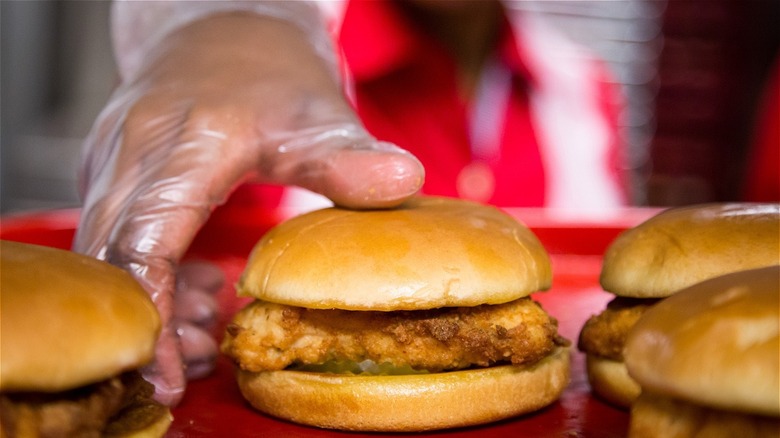 Employee grabbing Chick-fil-A sandwich