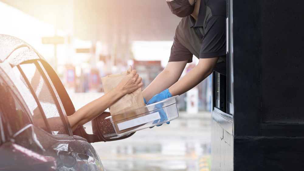 Employee handing over fast food order