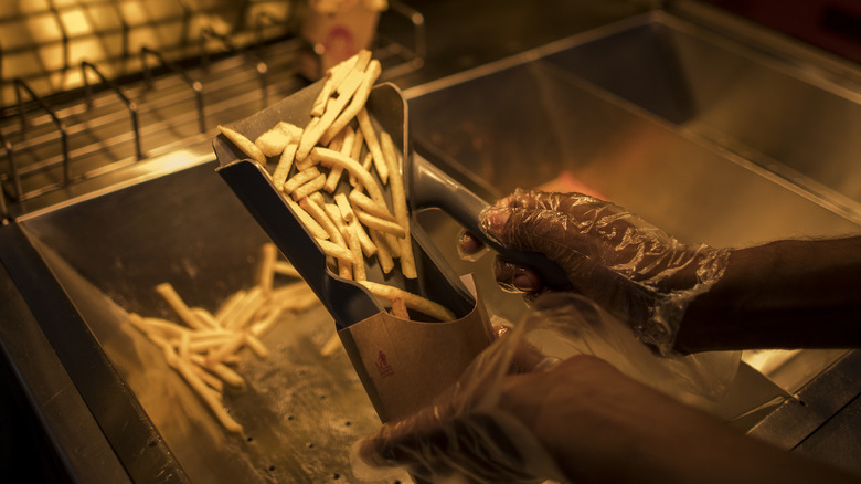 worker packing fries in a cloud kitchen