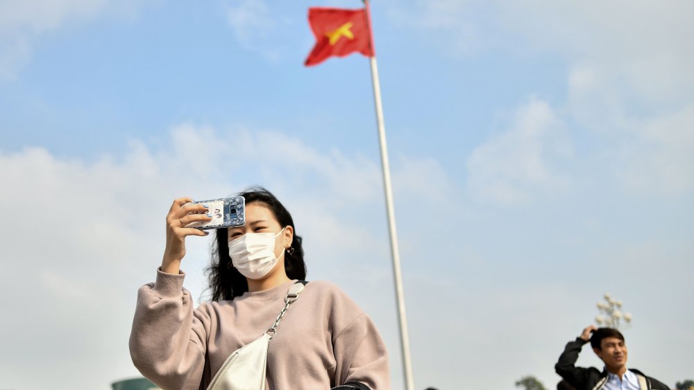 Woman in Ho Chi Minh City wearing protective face mask