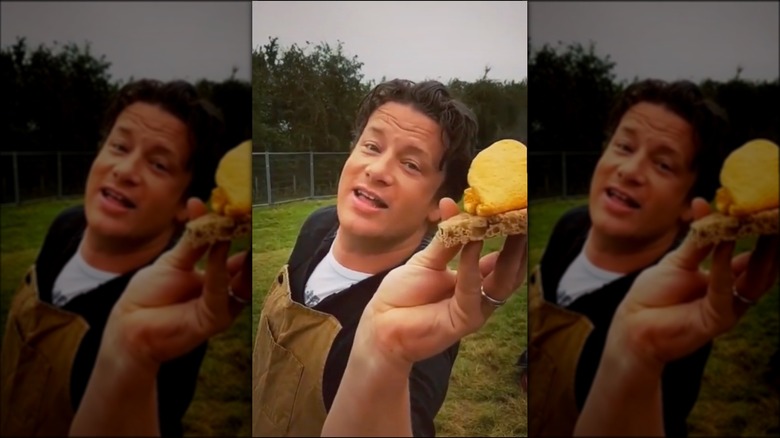 Jamie Oliver holding food