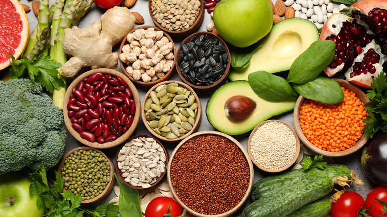 Vegetables, grains, and seeds laid out on table