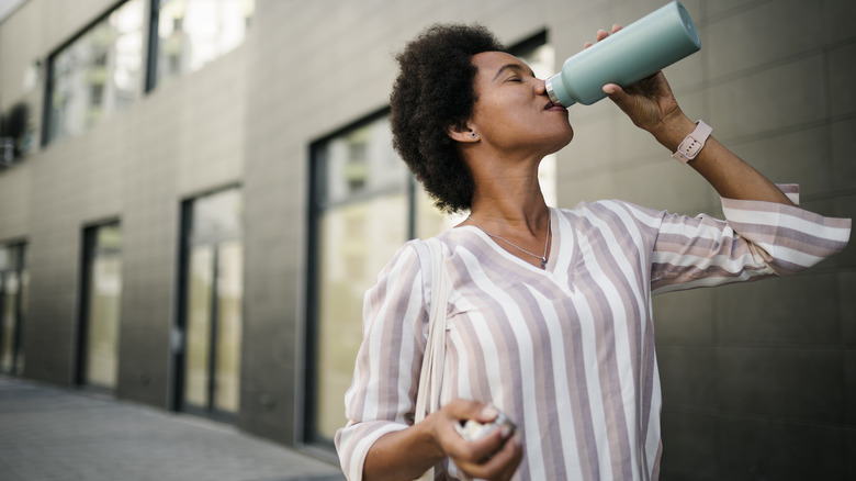 Woman drinking bottled water