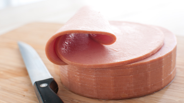 Slices of bologna with a knife
