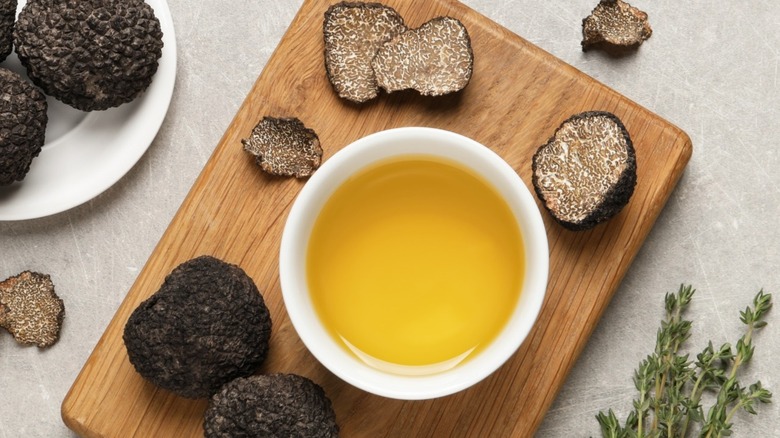 Truffles and truffle oil on a cutting board
