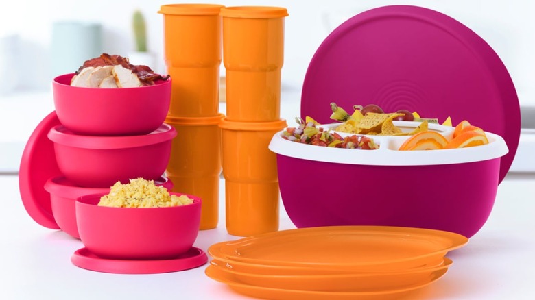 A selection of orange and fuchsia Tupperware  