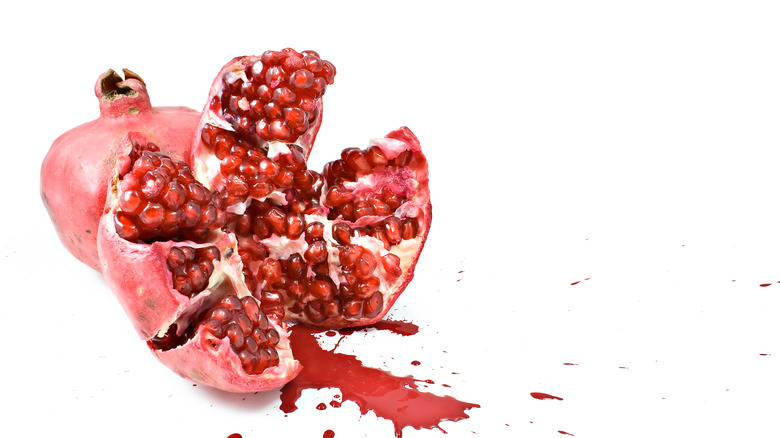 Smashed pomegranate on white background