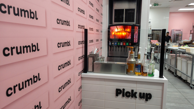 Crumbl Cookies pick-up counter with kitchen in the background
