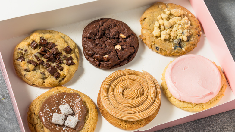 Pink box with assorted Crumbl cookies