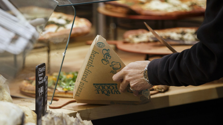 Person serving Whole Foods Pizza