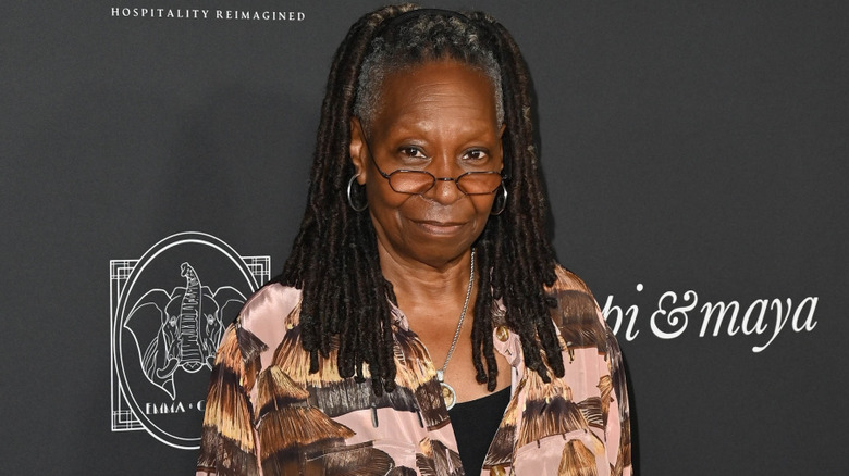 Whoopi Goldberg smiling at press appearance.