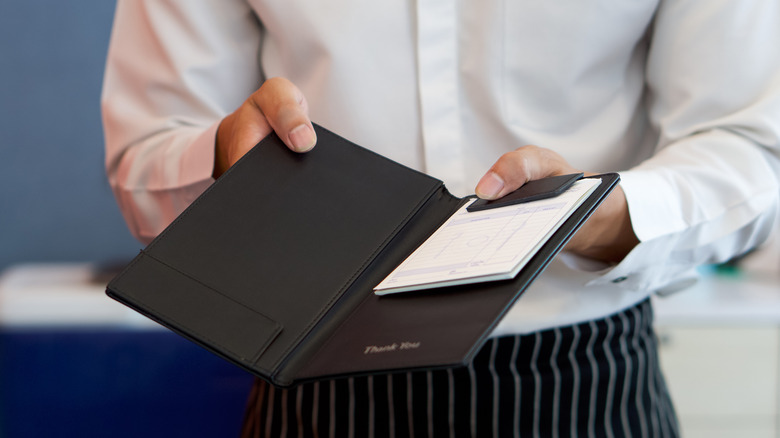 Server handing out a bill