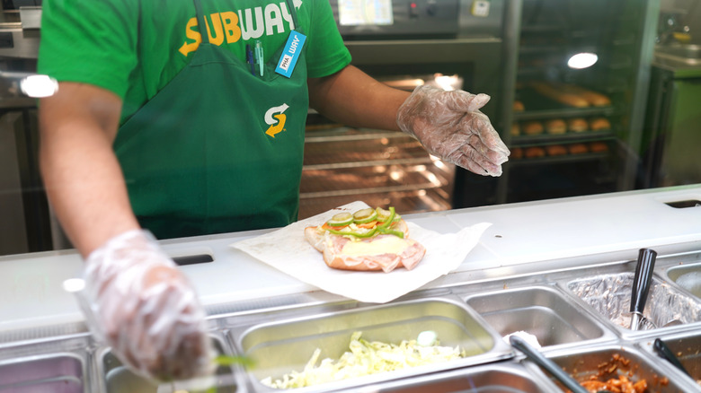 Subway employee making sandwich