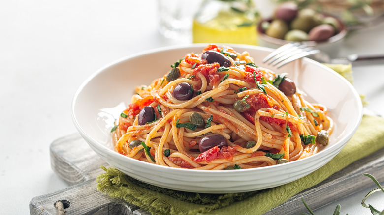 Plate of pasta with tomato sauce and olives