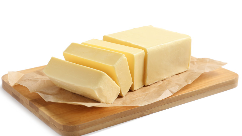 Sliced butter on cutting board