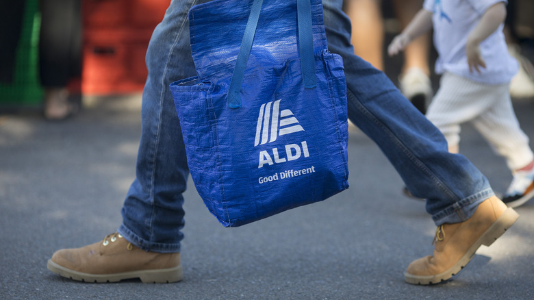 Person carrying Aldi bag