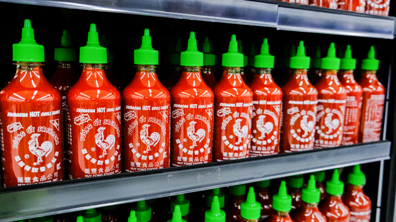 Rows of sriracha on grocery shelf