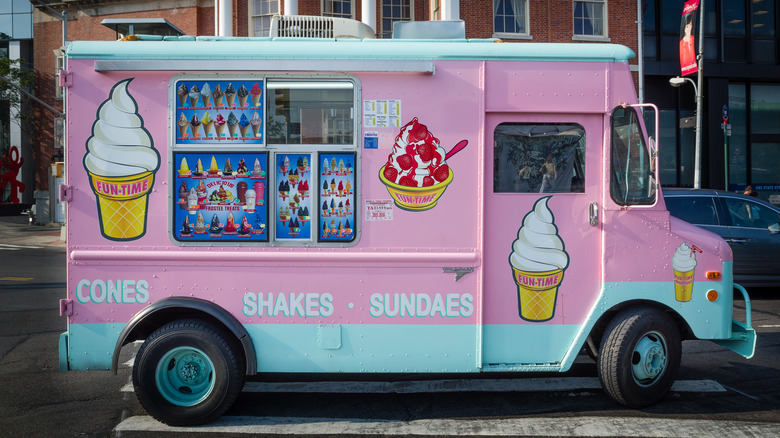 Pink and blue ice cream truck with menu of offerings.