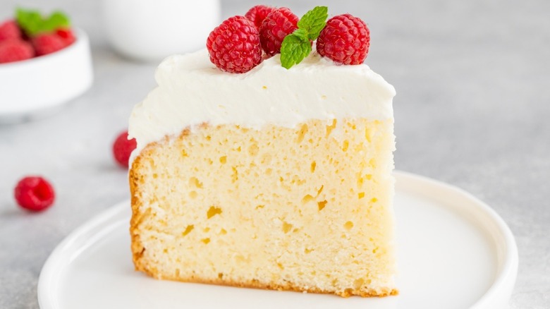 Piece of cake topped with raspberries