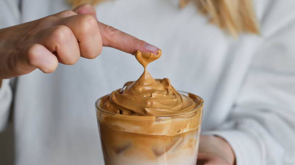 Woman holding Dalgona coffee