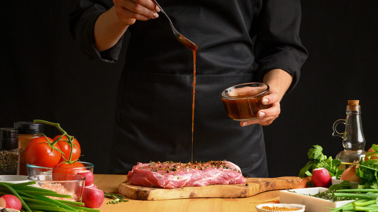 pouring marinade on beef