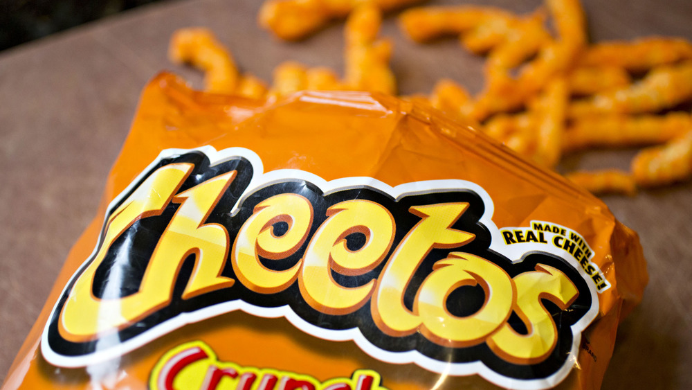 Top of an open bag of Cheetos, Cheetos in the background