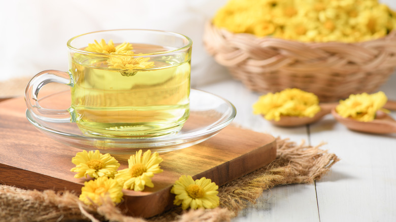 yellow flowers floating in cup