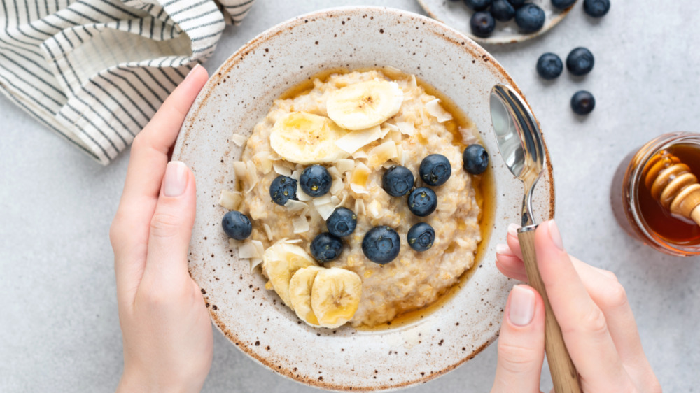 Person holding oatmeal bowl