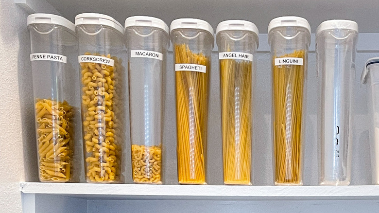 Dried pasta organized in plastic containers with labels