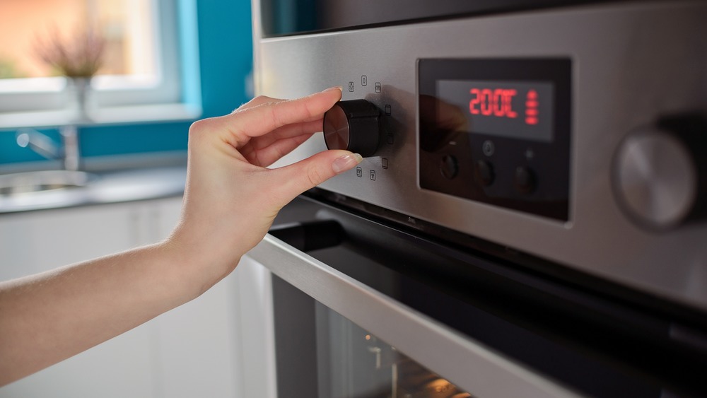 Person preheating oven