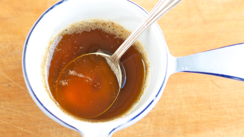 Brown butter in a metal spoon