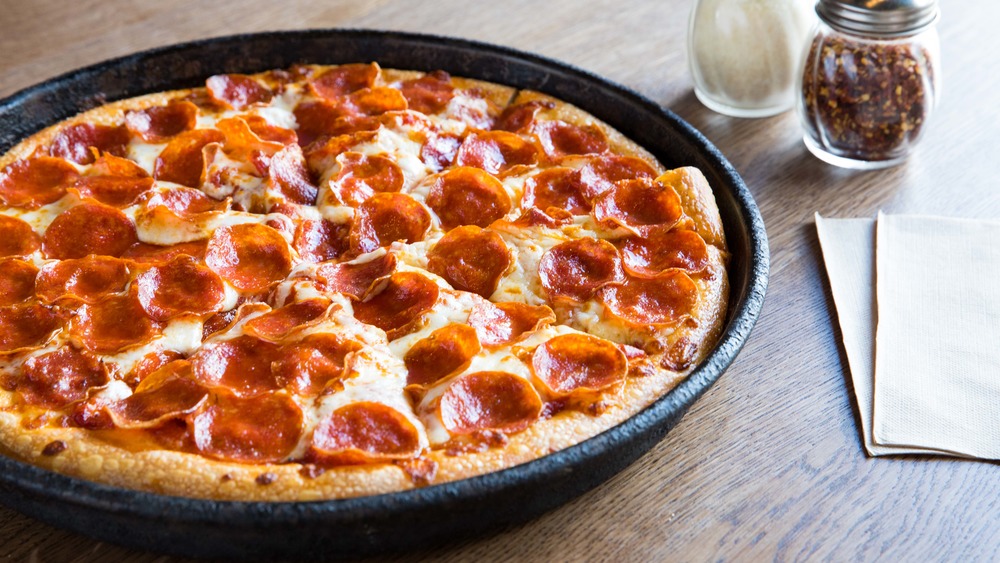 Pepperoni pizza in a pan on a table