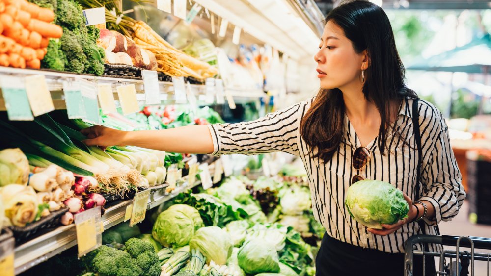 woman shopping produce section at grocery store