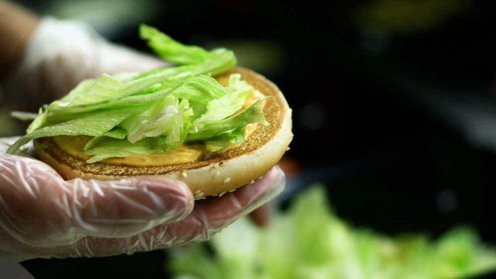 A staff member making a Burger King Whopper