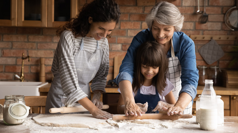 child, mother, and grandmother baking cookies