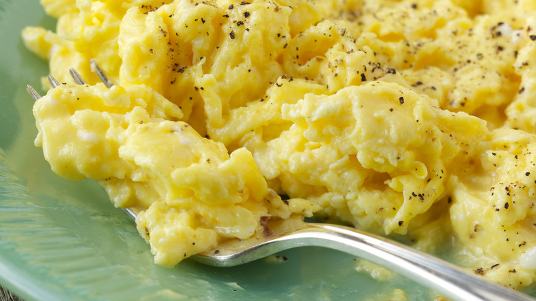 fluffy scrambled eggs close-up with pepper